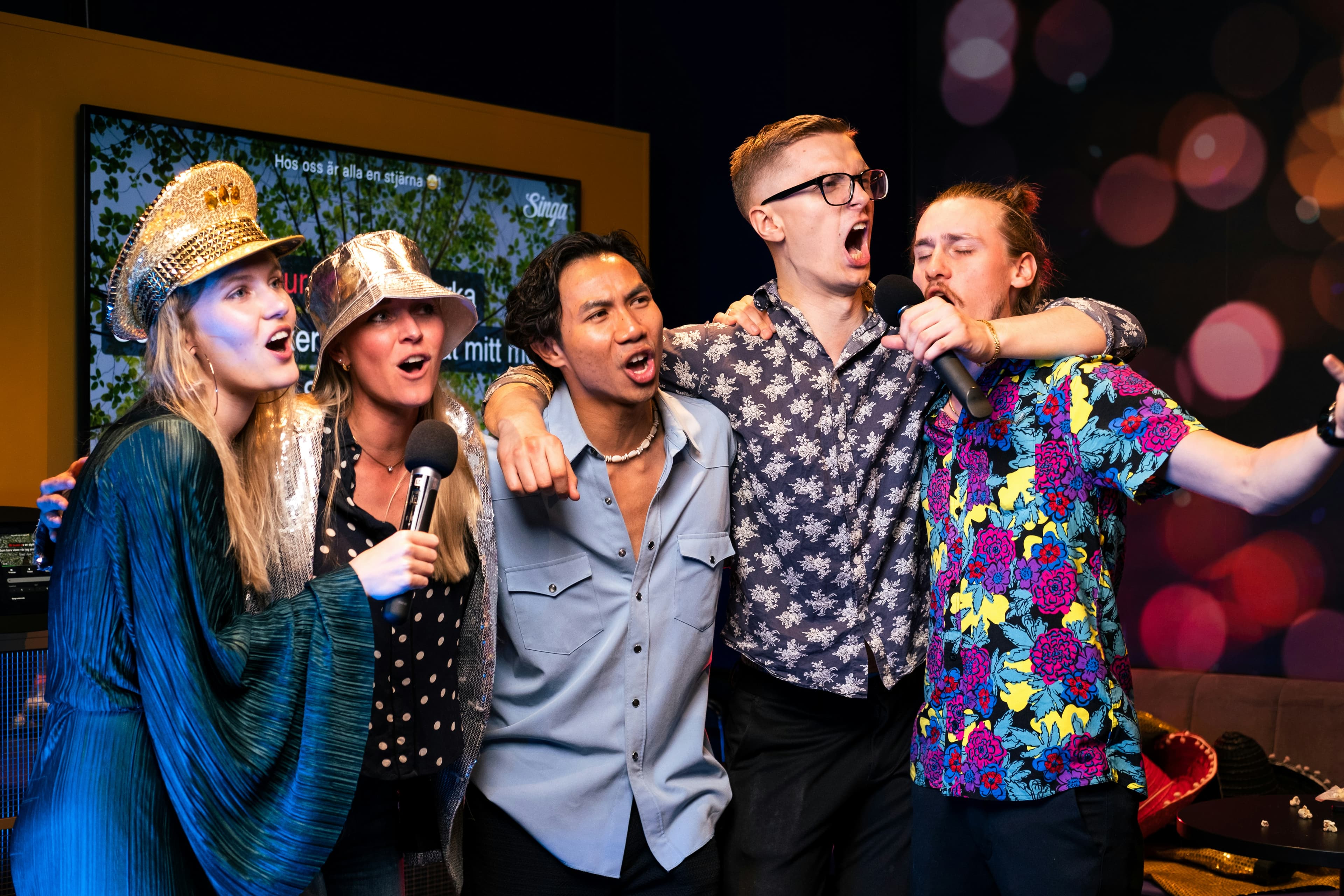 Woman singing karaoke with friends in private room at Karaoke Melody in Atlanta, GA